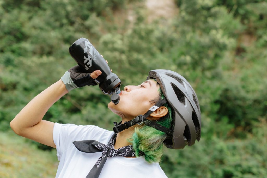Cyclist Drinking Water To Stay Hydrated In The Summer Heat