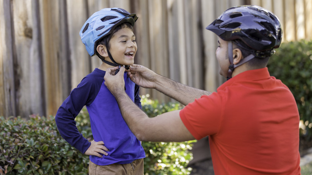 Wearing a protective gear before BMX riding