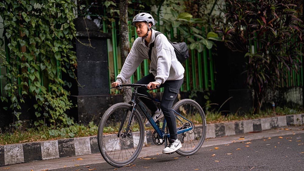 A cyclist on a city bike, enjoying the cityscape.