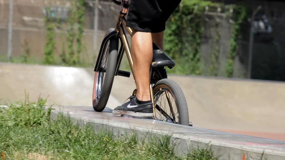 Peg grind stunt during a BMX street session