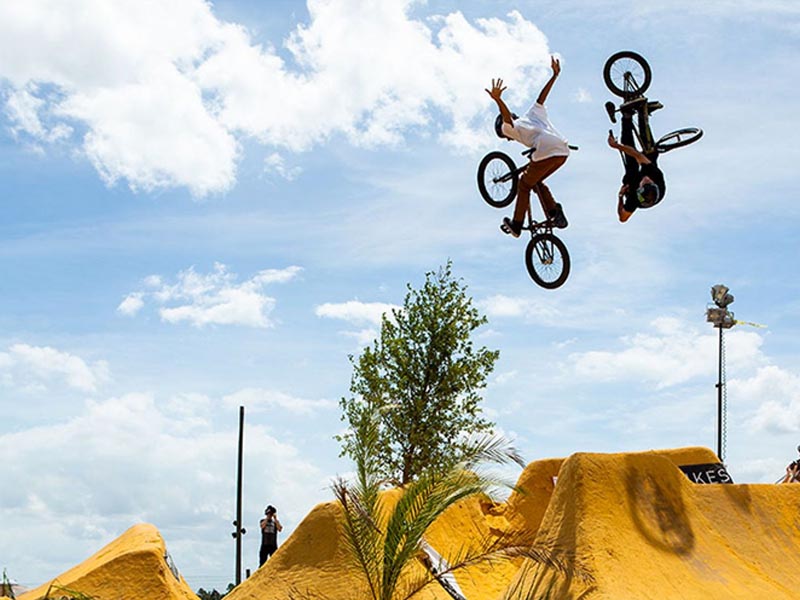 Skilled Rider Executing Bmx Tricks With Lasting Energy