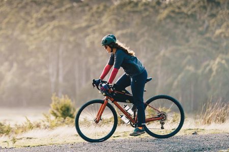 Cyclist On A Long Distance Bike Tour Through Scenic Countryside