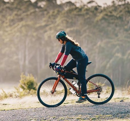 Cyclist On A Long Distance Bike Tour Through Scenic Countryside