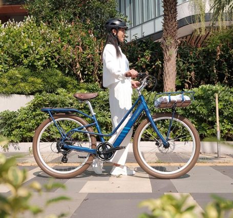 Female Cyclist Riding An Electric Bike
