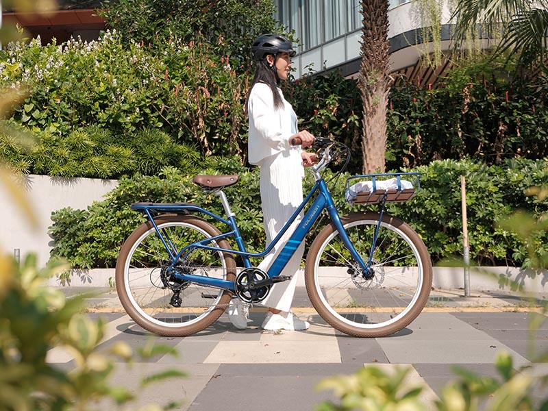 Female Cyclist Riding An Electric Bike