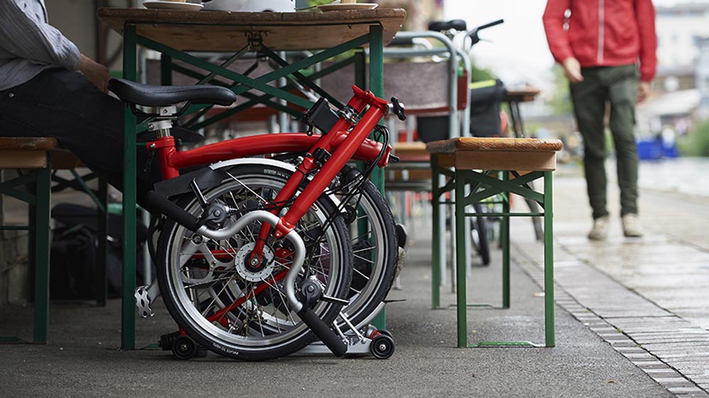 Compact storage of a folding bike beneath a table