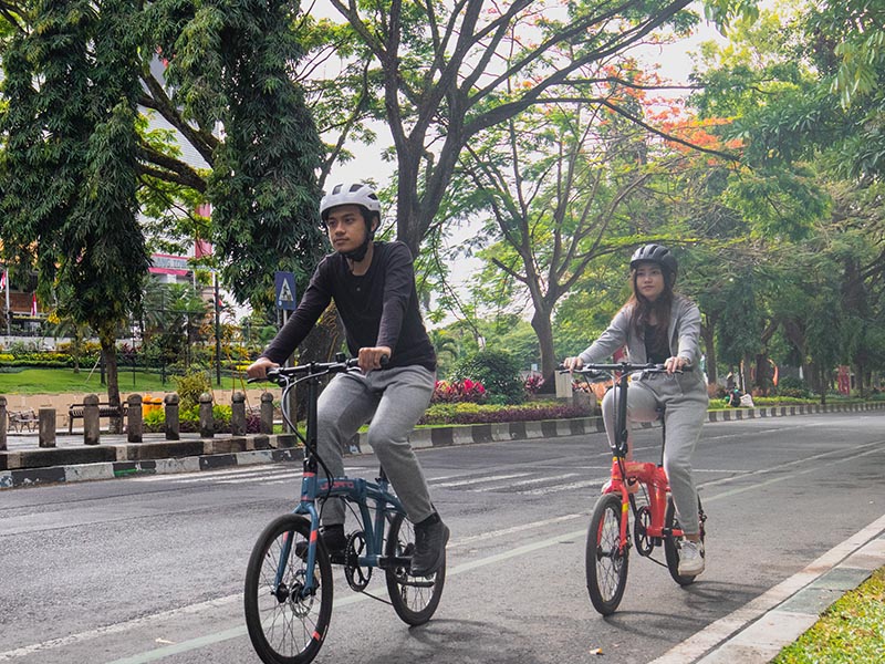 Riding A Foldable Bike On The Road