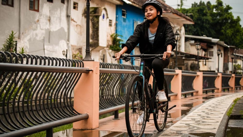 Riding A City Bike On A Wet Road