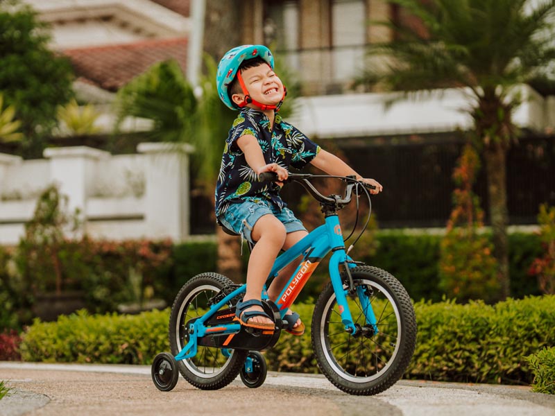 Riding A Training Wheel Kids Bike